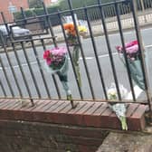 Floral tributes left along Thorns Road in Quarry Bank following a fatal road crash