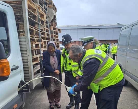 A colleague from the HMRC fuel testing unit showing his checks to officers and Cabinet Member for Public Health and Communities at Sandwell Council, Syeda Khatun.