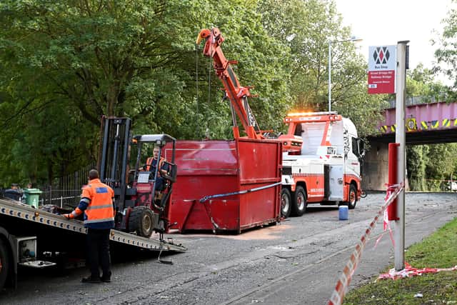 The skip is seen being recovered by specialist equipment