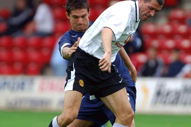 Taylor battling with Roy Keane during a pre-season friendly at the Bescot