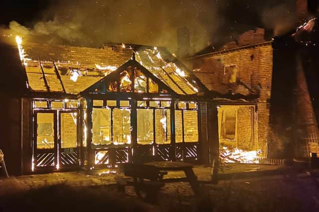 The Crooked House ablaze. Photo: Chris Green