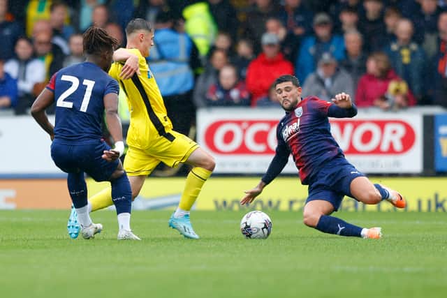Alex Mowatt fires into a tackle for Albion (Photo by Malcolm Couzens - WBA/West Bromwich Albion FC via Getty Images).