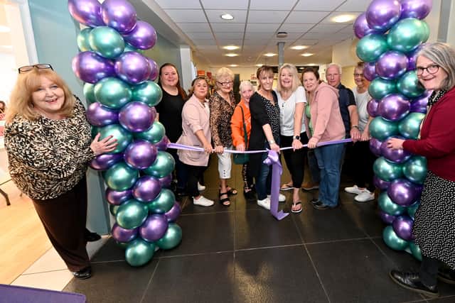 Centre manager Denise Robins (left) with Councillor Louise Miles (right) and volunteers as they cut the ribbon