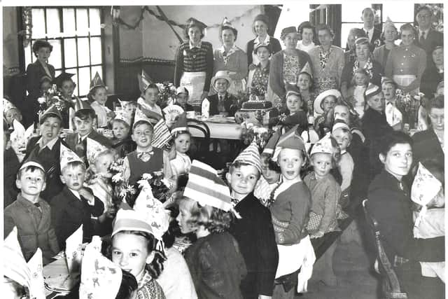 Douglas sitting on the top table, left hand side, wearing a top hat, his mother Hilda on his left.