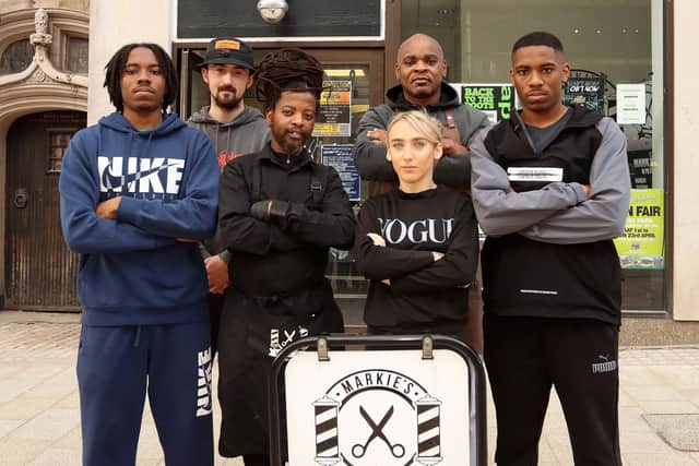 Mark Williams, third from left, with staff from Markie's Barbers in Victoria Street. Photo: David Linney Photography