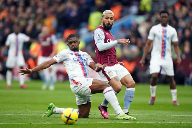 Crystal Palace's Cheick Doucoure slides in on Aston Villa's Douglas Luiz