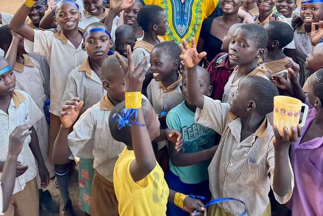 Samuel surrounded by the children of the school