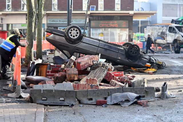 One of the overturned cars.