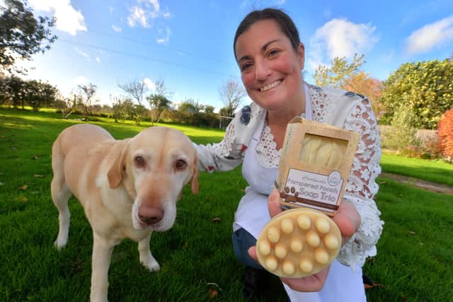 Karen Blanchfield with soaps made for dogs and her dog Candy