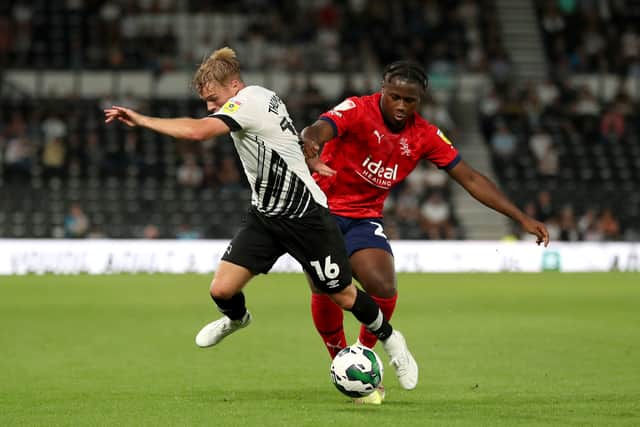 Liam Thompson of Derby County and Reyes Cleary of West Bromwich Albion during the Carabao Cup Second Round match between Derby County and West Bromwich Albion at Pride Park Stadium on August 23, 2022 in Derby, England. (Photo by Adam Fradgley/West Bromwich Albion FC via Getty Images).