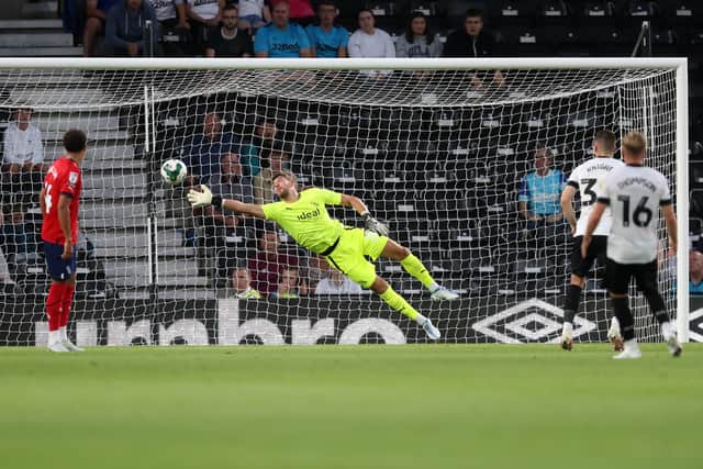 Louie Sibley of Derby County (out of frame) scores a goal to make it 1-0 past Alex Palmer of West Bromwich Albion during the Carabao Cup Second Round match between Derby County and West Bromwich Albion at Pride Park Stadium on August 23, 2022 in Derby, England. (Photo by Adam Fradgley/West Bromwich Albion FC via Getty Images).