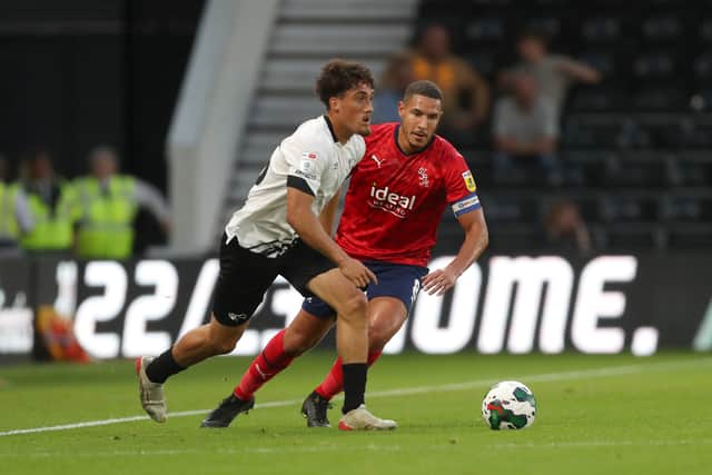 Haydon Roberts of Derby County and Jake Livermore of West Bromwich Albion during the Carabao Cup Second Round match between Derby County and West Bromwich Albion at Pride Park Stadium on August 23, 2022 in Derby, England. (Photo by Adam Fradgley/West Bromwich Albion FC via Getty Images).