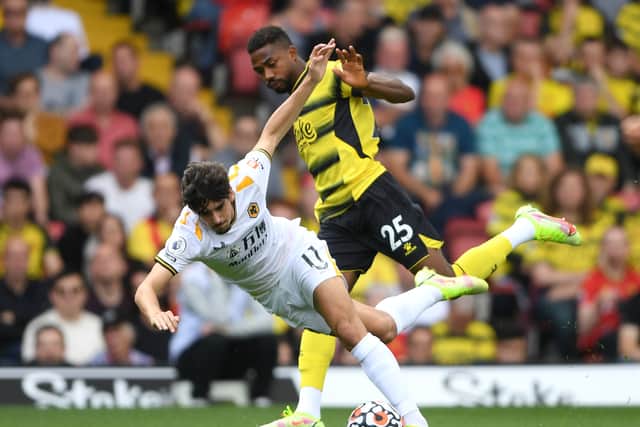 WATFORD, ENGLAND - SEPTEMBER 11: Francisco Trincao of Wolverhampton Wanderers is challenged by Emmanuel Dennis of Watford FC during the Premier League match between Watford and Wolverhampton Wanderers at Vicarage Road on September 11, 2021 in Watford, England. (Photo by Harriet Lander - WWFC/Wolves via Getty Images).