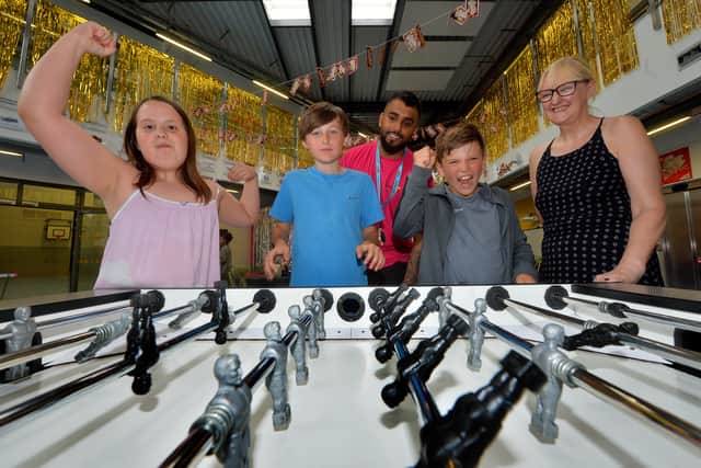 Julia Olowniuk, aged nine, 12-year-old Owen Davis, and 11-year-old Oliver Homer, with a youth worker and chief executive Jackie Redding