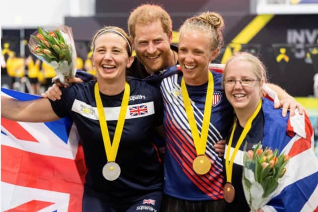 Kelly celebrating one of her silver medal successes with Team UK colleagues and Prince Harry.