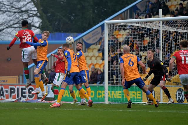 Tyrese Shade rises high to head the ball towards the Mansfield goal