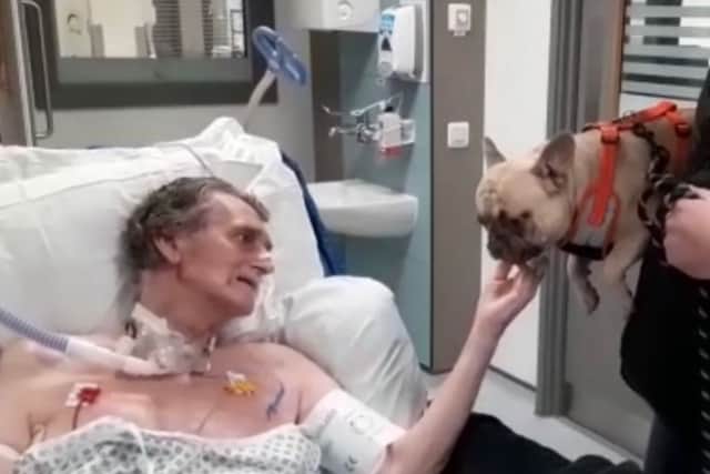 Vic Sharrard being visited by his beloved dog, Ralph