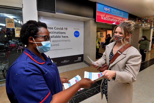 Clinical lead Fran Acquah from Bilston chats to Sasha Shackell-York from Tividale outside the Mander Centre vaccination centre