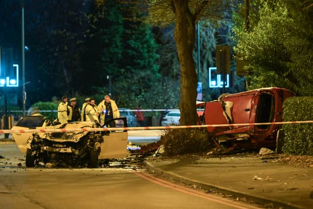 **Number plates may need pixelating - Moving Footage with relevant desk** (Pictured: West Midlands Police collision investigation officers examine the wreckage of two vehicles that collided at a junction close to the Walsall campus of Wolverhampton University on the road called Broadway. A woman has died in the impact. A red and white car were seen badly damaged with the red car on its side wedged between a tree and a bush with its roof cut open by the fire service. Pic taken: 21/11/2021) -.