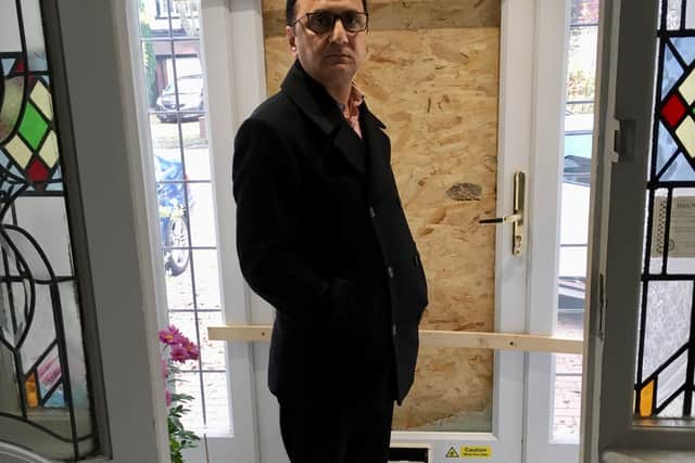Councillor Waheed Rasab in front of his boarded up front door. Photo: Gurdip Thandi
