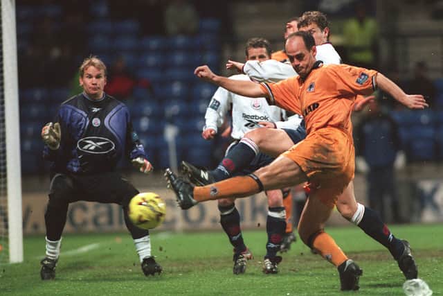 Bolton goalkeeper Jussi Jaaskelainen looks a worried man as Wolves Spanish midfielder Fernando Gomez hits the side netting.