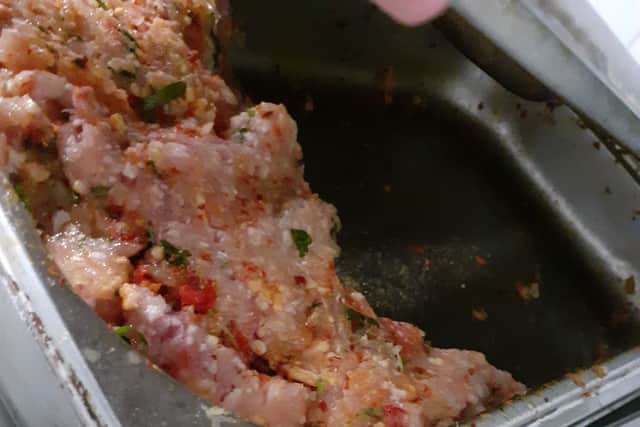 Seasoned/flavoured raw meat in a container at the restaurant