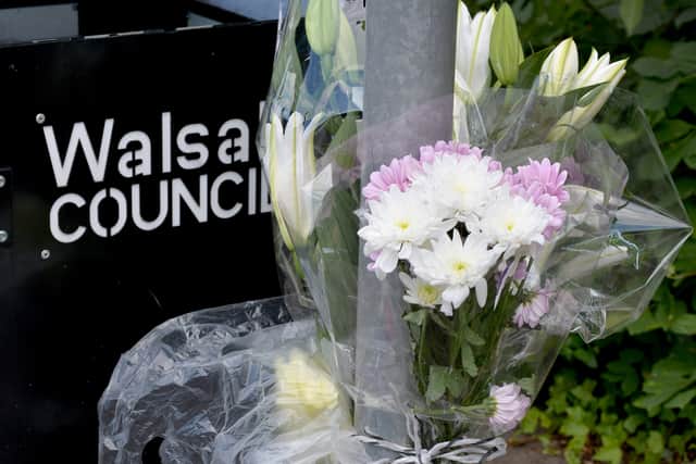 Tributes at the scene of the crash where a cyclist died after being hit on the crossing on Tuesday morning on Lower Rushall Street, Walsall