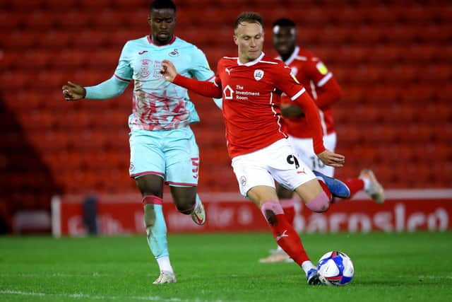 Swansea City's Marc Guehi (left) and Barnsley's Cauley Woodrow