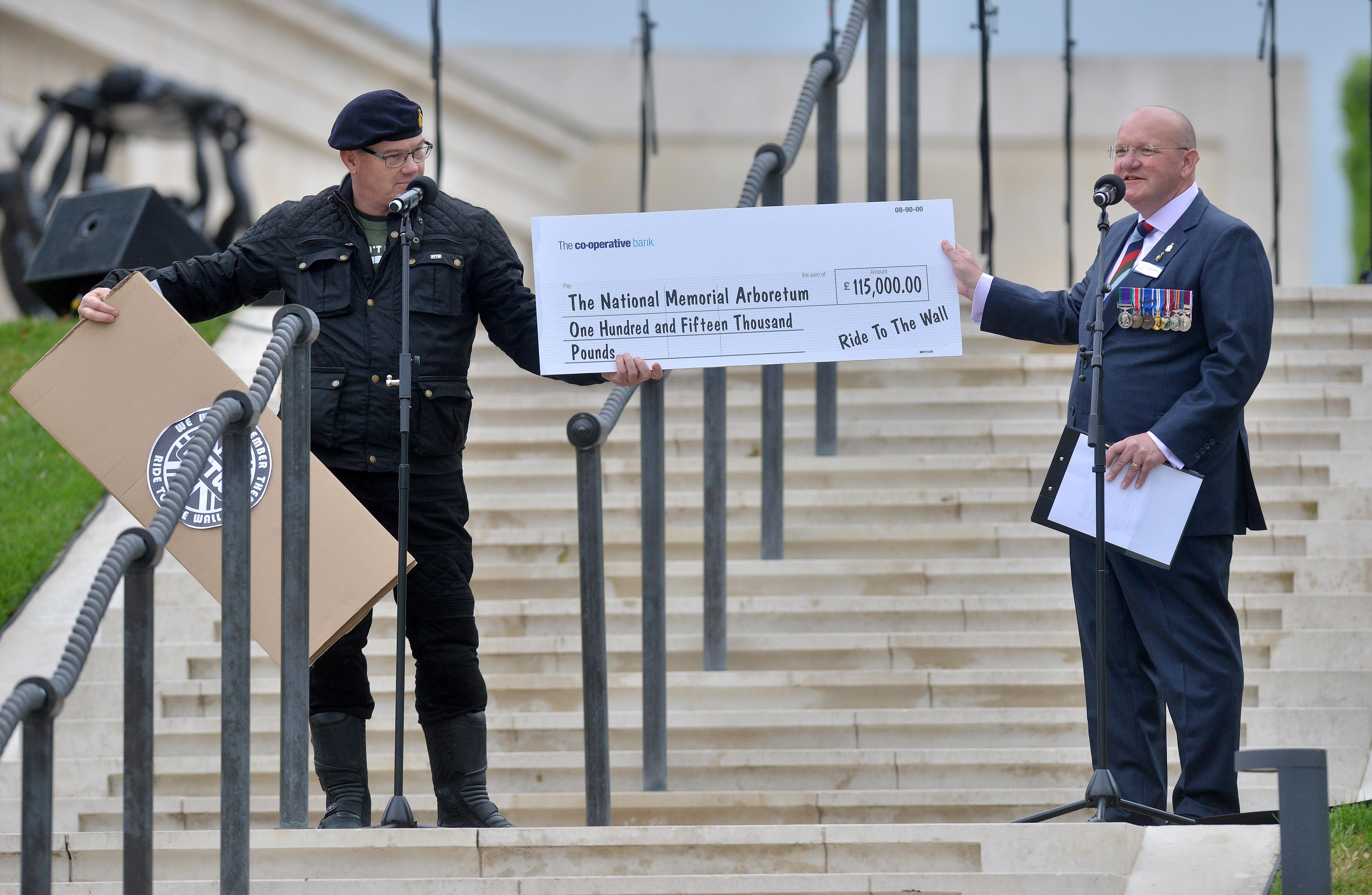 Money raised from the 'Ride to the Wall' event is presented to the Arboretum