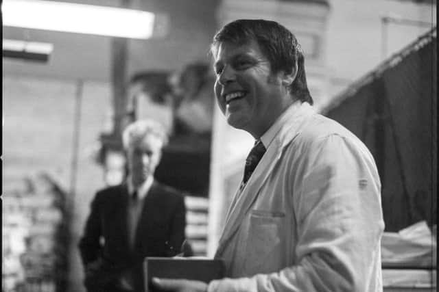 A cheery wholesaler seems to be enjoying his work during the market's last days