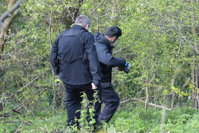 Police at the scene next to Junction 9 of the M6 where human remains were found. Photo: SnapperSK