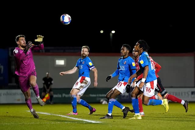 Lincoln City's Alex Palmer saves a shot on goal