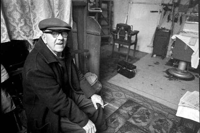 A man waiting for a haircut at Teddy McGovan's barbershop