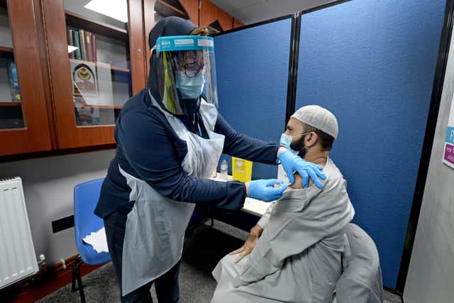 Imam of the mosque Muhammad Saeed arrives for his vaccination