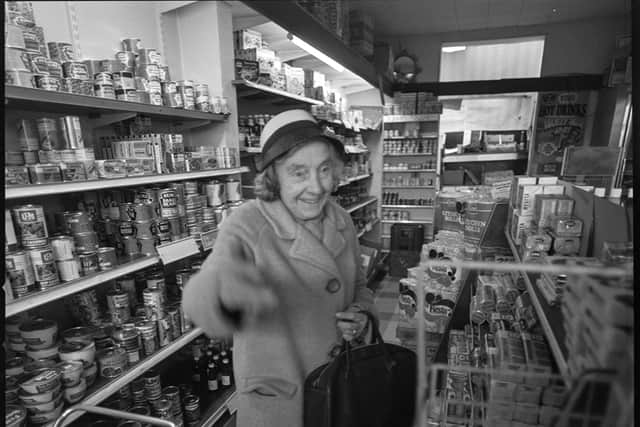 An elderly customer gets to grips with the new self-service supermarket