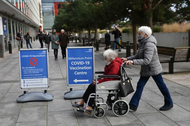 Members of the public arrive to receive their injection of a Covid-19 vaccine at the NHS vaccine centre that has been set up at the Millennium Point centre in Birmingham
