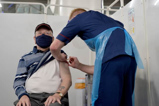 Mass vaccination centre opens at Millennium Point, Birmingham. Pictured, Ken Hughes, ages 82, from Swindon, gets the jab