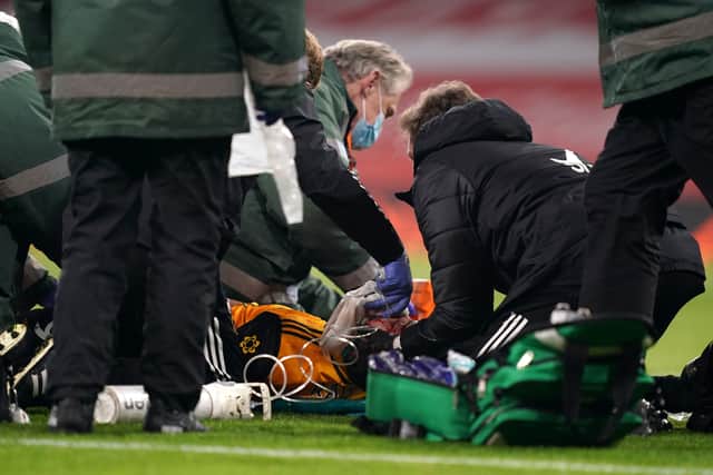 Raul Jimenez receiving treatment after a clash of heads with Arsenal's David Luiz