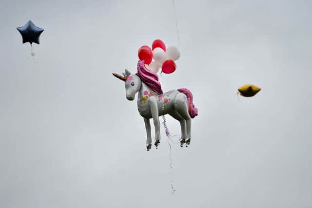 Balloons are released into the sky at Dell Stadium
