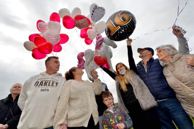 Balloons are released into the sky at Dell Stadium