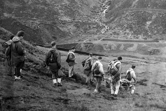 The mountain rescue unit, with stretcher and rescue equipment, set off on a mission in the Peak District in 1960