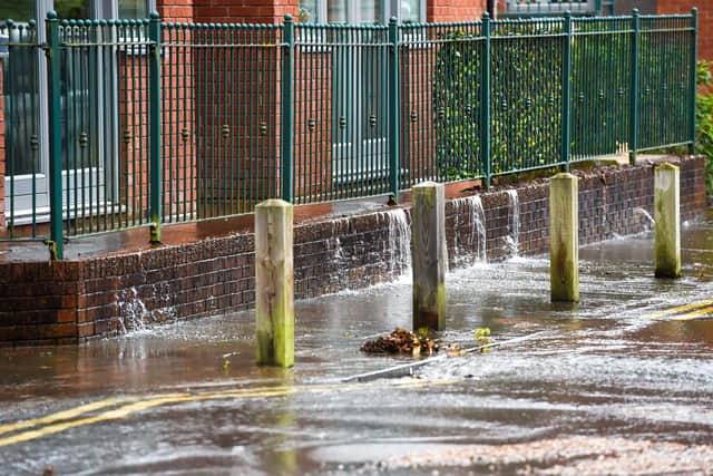 Firefighters and Severn Trent workers at the flooded road in Northfield, Birmingham. Photo: SnapperSK