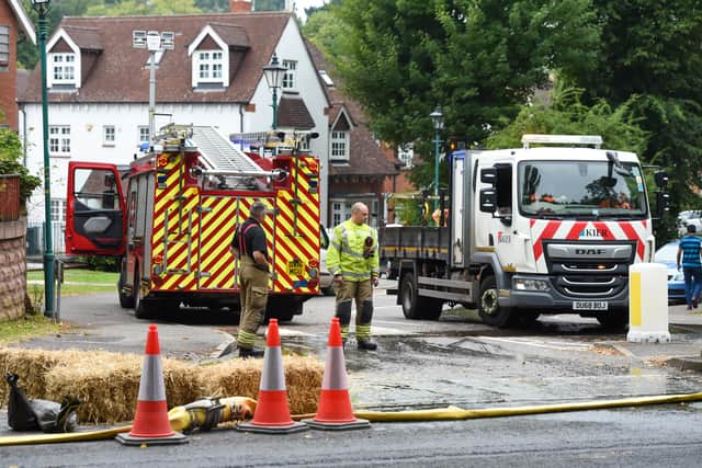 Firefighters and Severn Trent workers at the flooded road in Northfield, Birmingham. Photo: SnapperSK