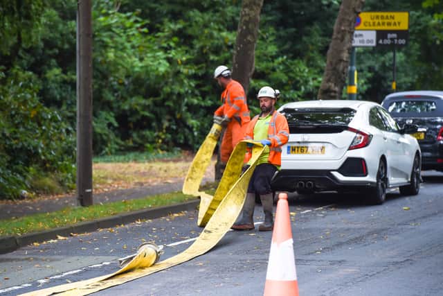 Firefighters and Severn Trent workers at the flooded road in Northfield, Birmingham. Photo: SnapperSK