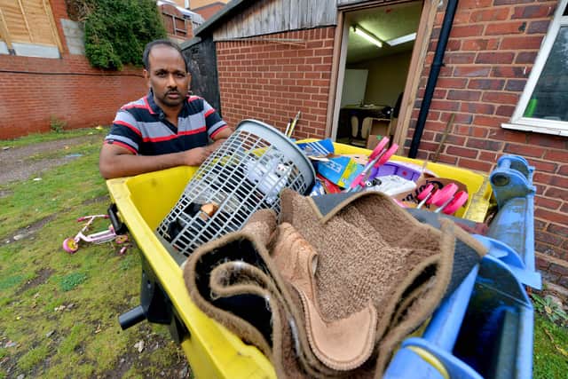 Raj Rasakumaran at his home and shop which has been flooded in Toll End Road