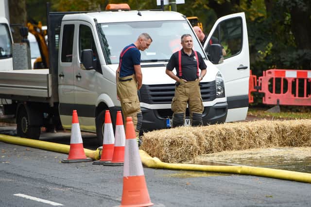Firefighters and Severn Trent workers at the flooded road in Northfield, Birmingham. Photo: SnapperSK