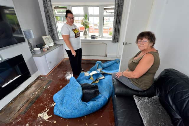 Georgina Reynolds and her mother Terri Wilkinson survey the damage left by floods in Walker Street, Tipton