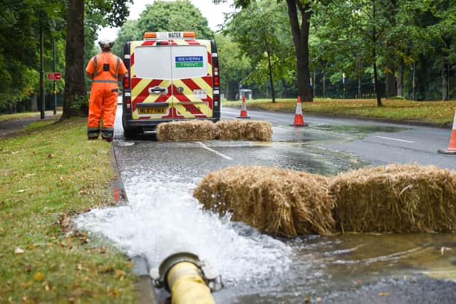 Firefighters and Severn Trent workers at the flooded road in Northfield, Birmingham. Photo: SnapperSK