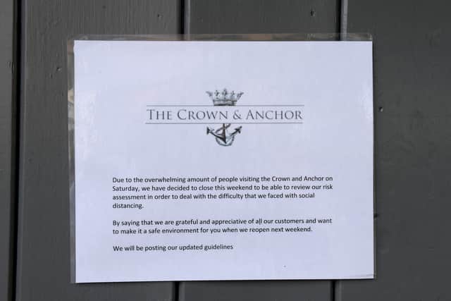 A sign on the door of the Crown and Anchor pub states it was closing last weekend