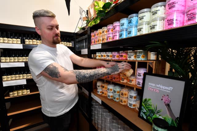 Ryan stocks the shelves at COW Home & Body in Hednesford. Photo: Tim Thursfield